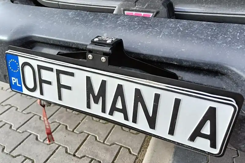 Folding license plate holder for winch guide